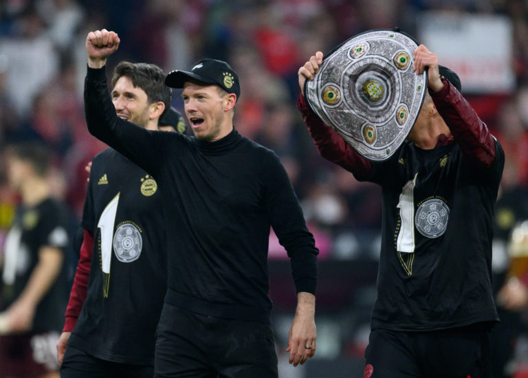 MUNICH, GERMANY - APRIL 23: Julian Nagelsmann, Head Coach of FC Bayern Muenchen celebrates with a replica Bundesliga trophy after their sides victo...