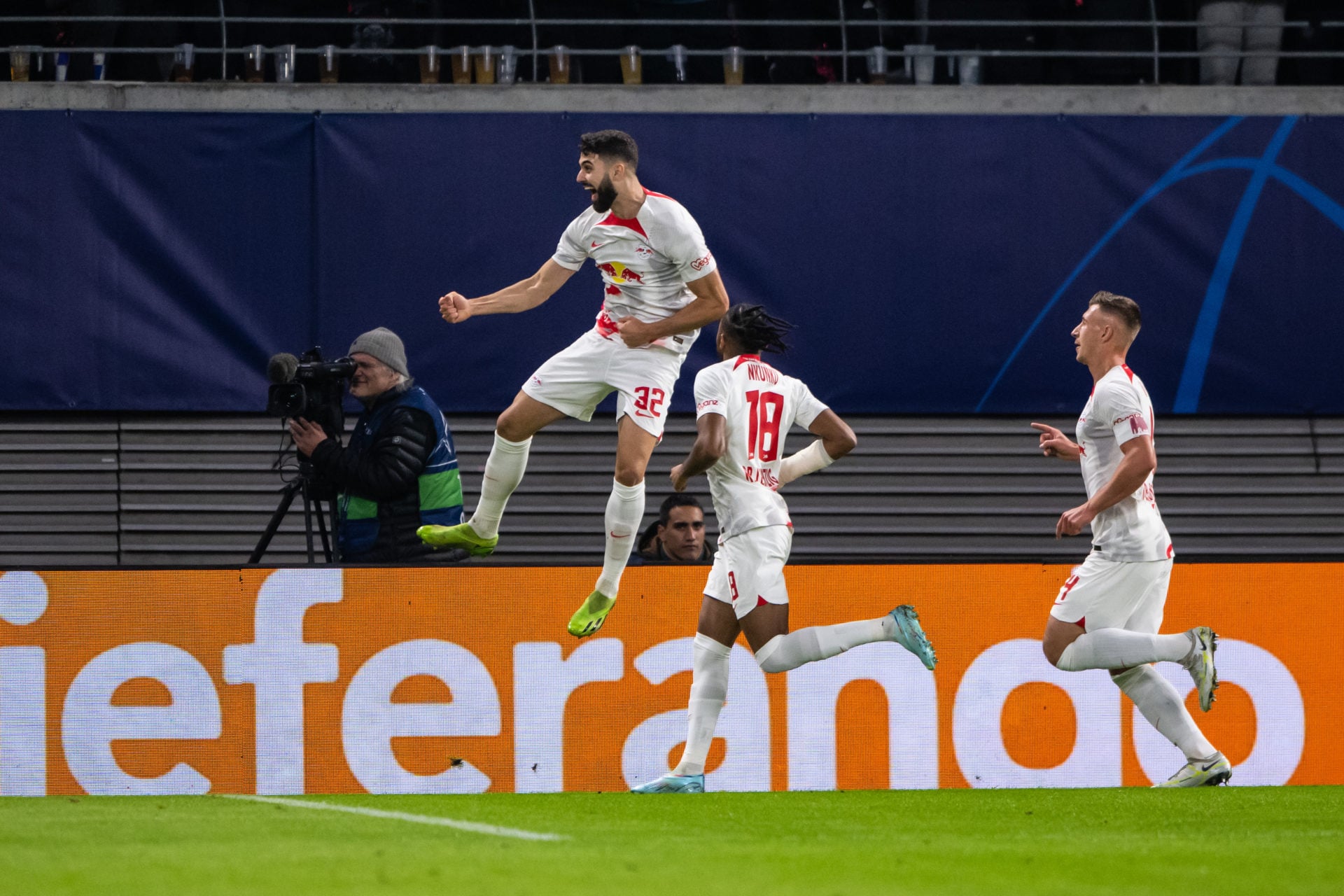 LEIPZIG, GERMANY - OCTOBER 25: Josko Gvardiol (L) of RB Leipzig celebrates after scoring his team's first goal with Christopher Nkunku (C) and Will...