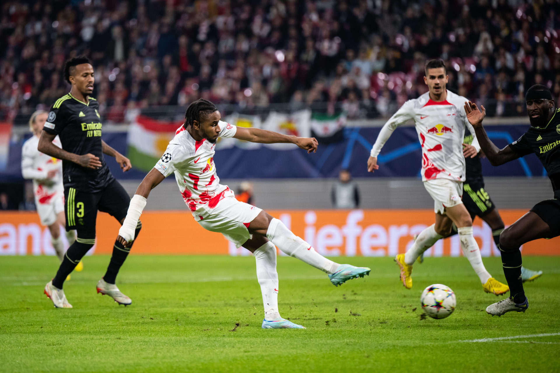 LEIPZIG, GERMANY - OCTOBER 25: Christopher Nkunku of RB Leipzig shoots during the UEFA Champions League group F match between RB Leipzig and Real M...