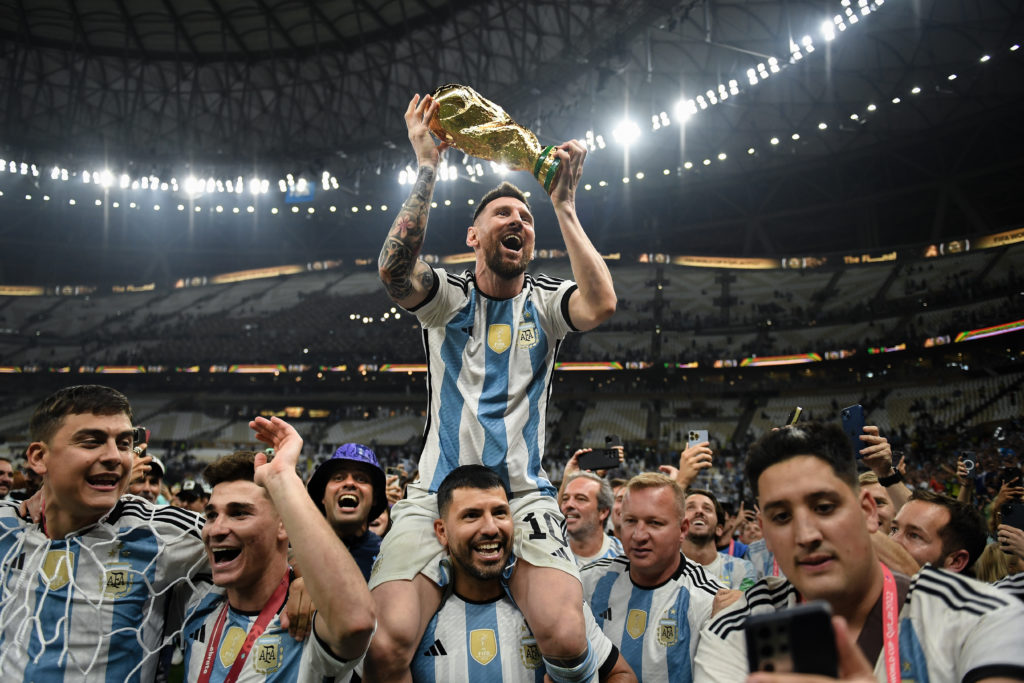 Lionel Messi celebrates with his teammates after winning the 2022 World Cup in Qatar.