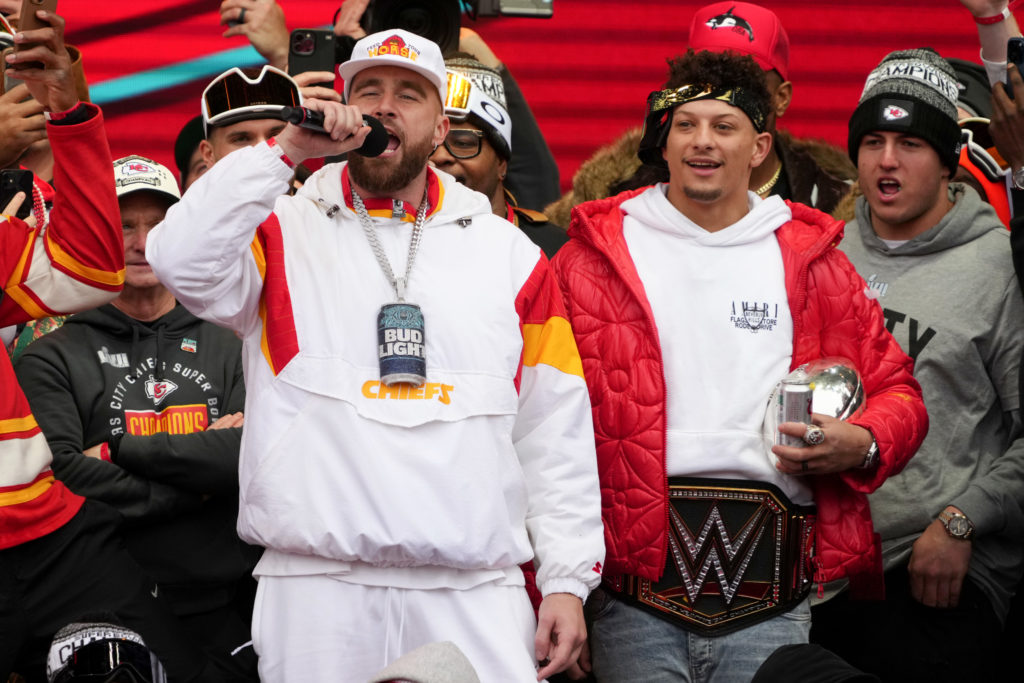 Travis Kelce #87 and Patrick Mahomes #15 of the Kansas City Chiefs celebrate on stage during the Kansas City Chiefs Super Bowl LVII victory parade on February 15, 2023 in Kansas City.
