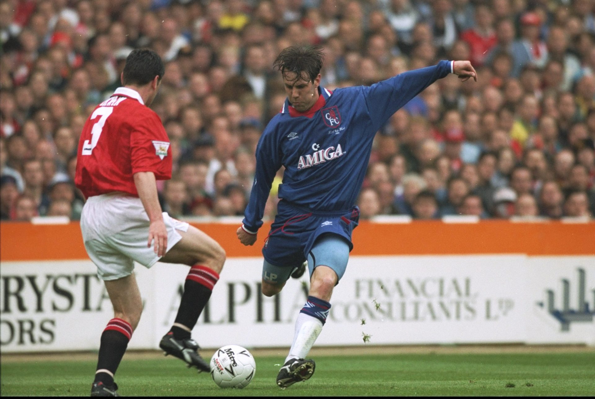 14 May 1994: Denis Irwin (left) of Manchester United tries to block the shot of Craig Burley (right) of Chelsea during the FA Cup Final at Wemble...