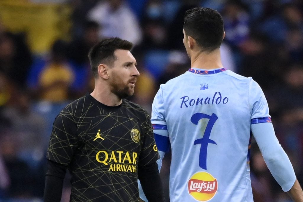 Paris Saint-Germain's Argentine forward Lionel Messi (L) walks past Riyadh All-Star's Portuguese forward Cristiano Ronaldo (R) during the Riyadh Season Cup football match between the Riyadh All-Stars and Paris Saint-Germain at the King Fahd Stadium.