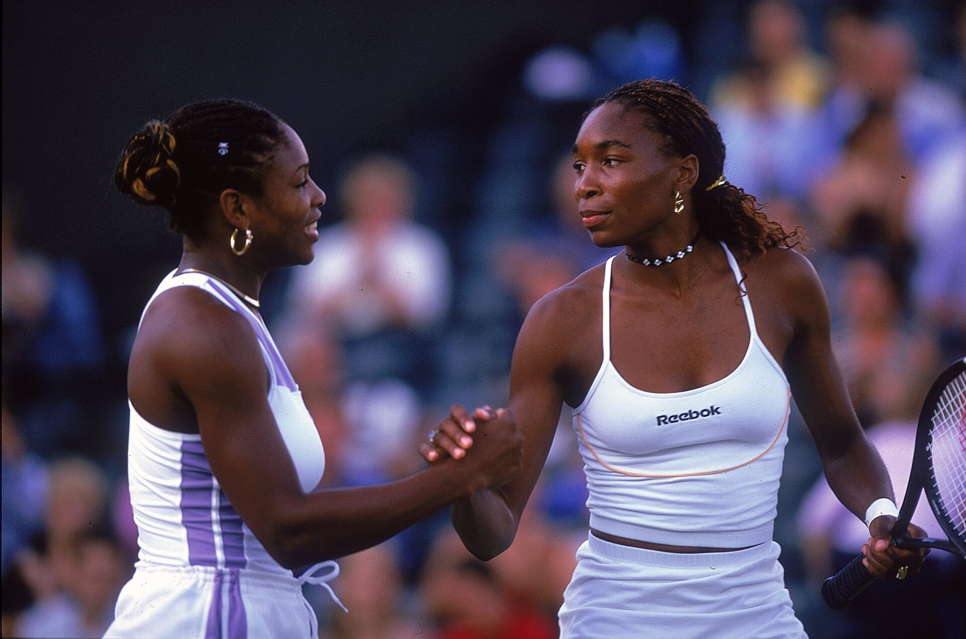3 Jul 2000: Serena (left) and Venus Williams of the USA celebrate after their second round ladies doubles match during the Wimbledon Championships...