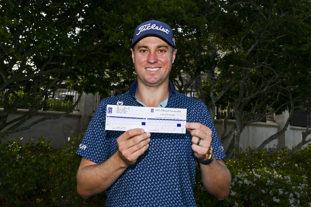 Justin Thomas shows his scorecard after tying the TPC Sawgrass course record at The Players Championship