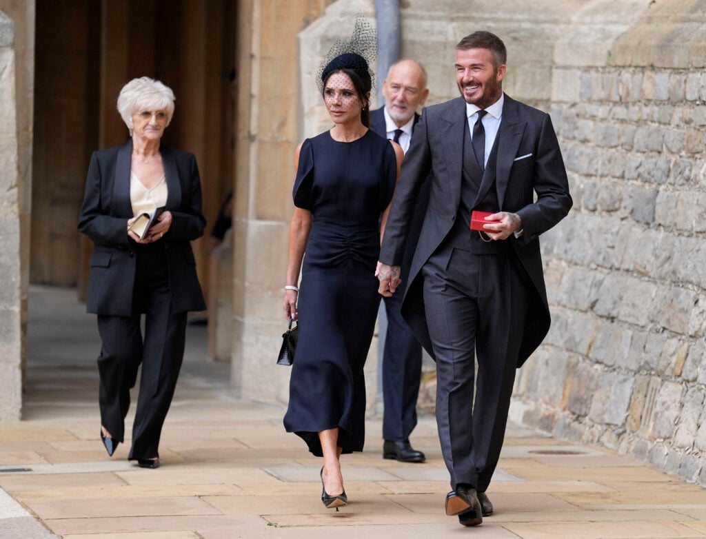 David and Victoria Beckham walk out into the yard