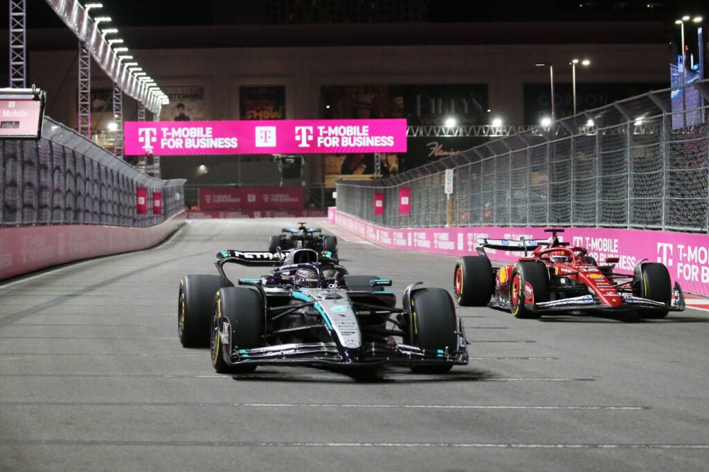 George Russell passing Charles Leclerc during FP1 at the Las Vegas Grand Prix.