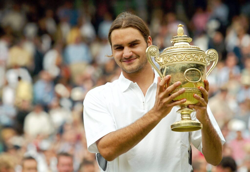 Roger Federer poses with the 2003 Wimbledon trophy after beating Mark Philippoussis.