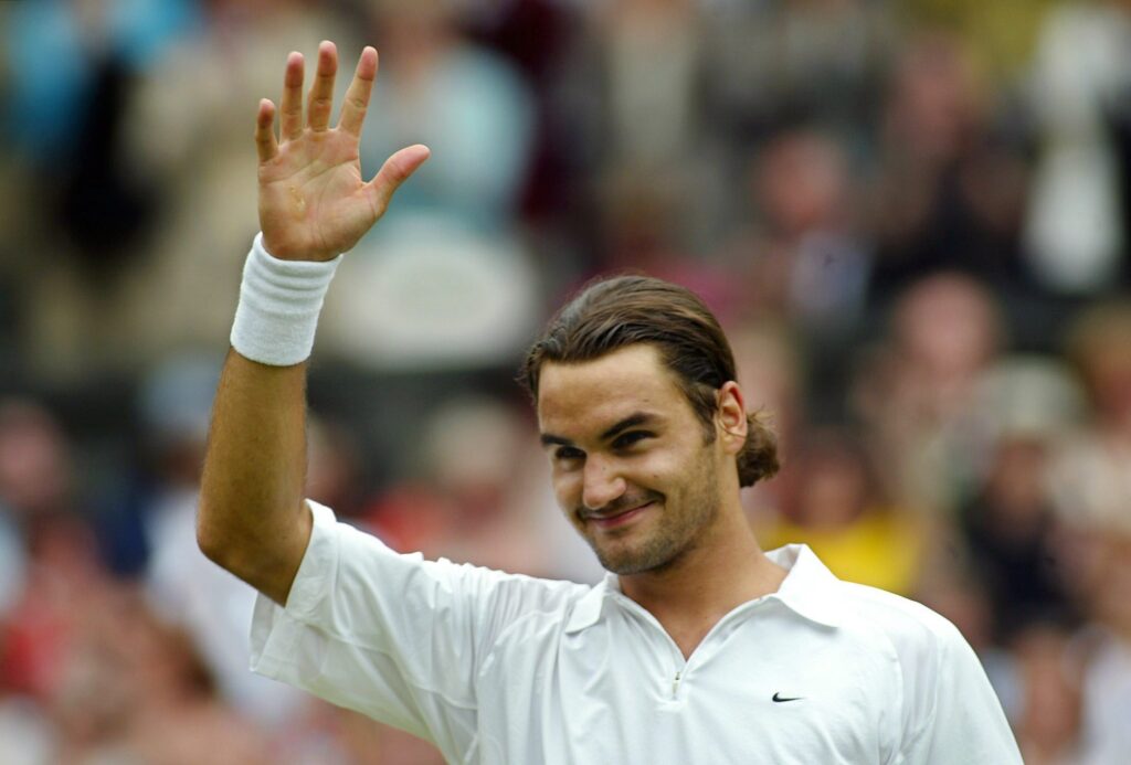 Roger Federer waves to the crowd after winning the 2003 Wimbledon title.