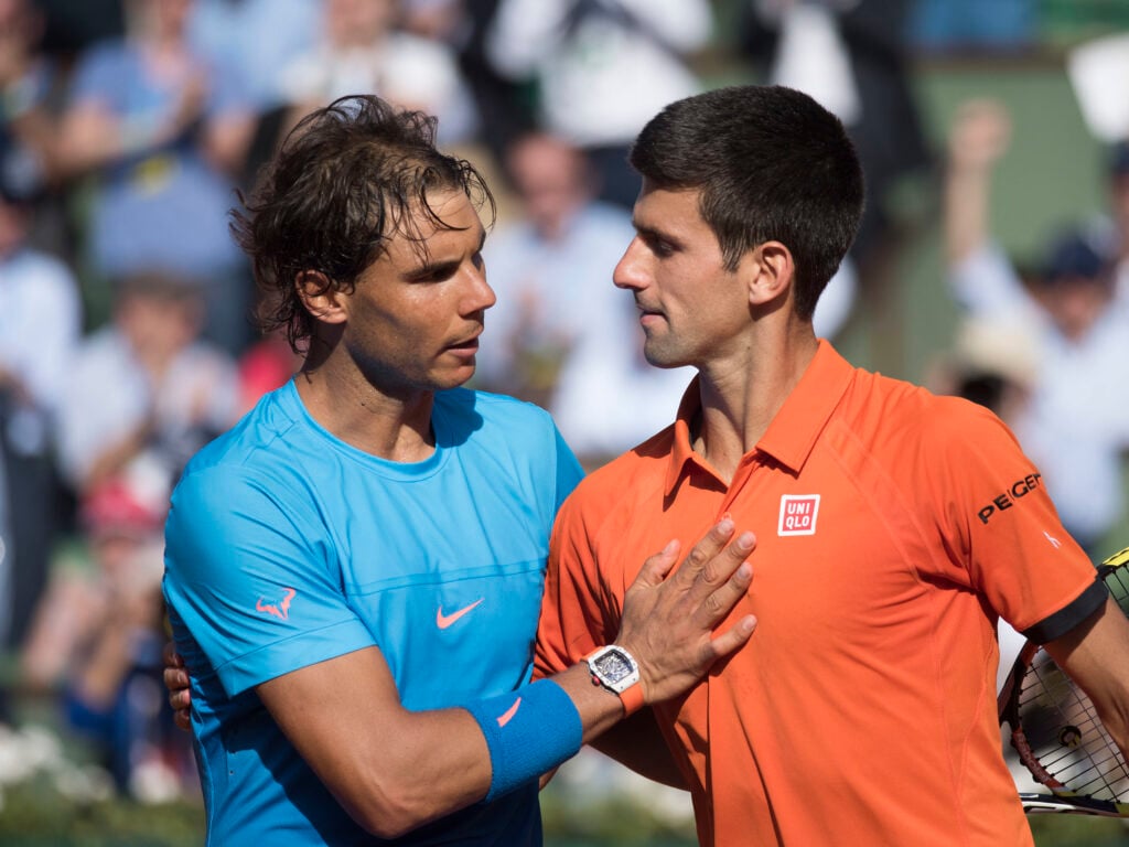 Rafael Nadal and Novak Djokovic embrace after their match at the 2015 French Open