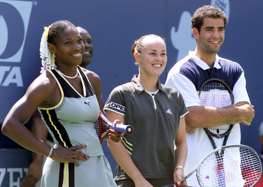 Serena Williams, Martina Hingis and Pete Sampras smile, stood in a line