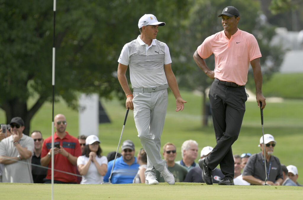 Rickie Fowler and Tiger Woods chat on the 11th green during the second round of the BMW Championship at Aronimink Golf Club on September 7, 2018.