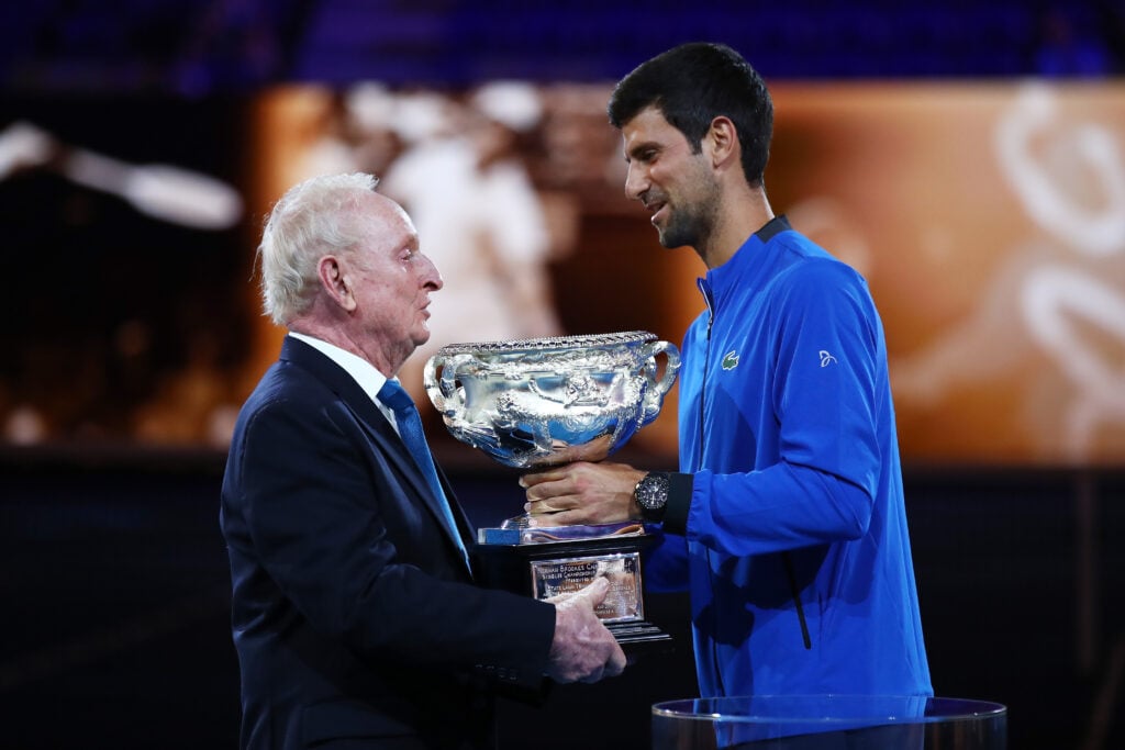Novak Djokovic presents Rod Laver with the Norman Brookes Challenge Cup during the 50th anniversary celebration for Australian Open and Rod Laver's second Grand Slam during day one of the 2019 Australian Open at Melbourne Park on January 14, 2019 in Melbourne, Australia.