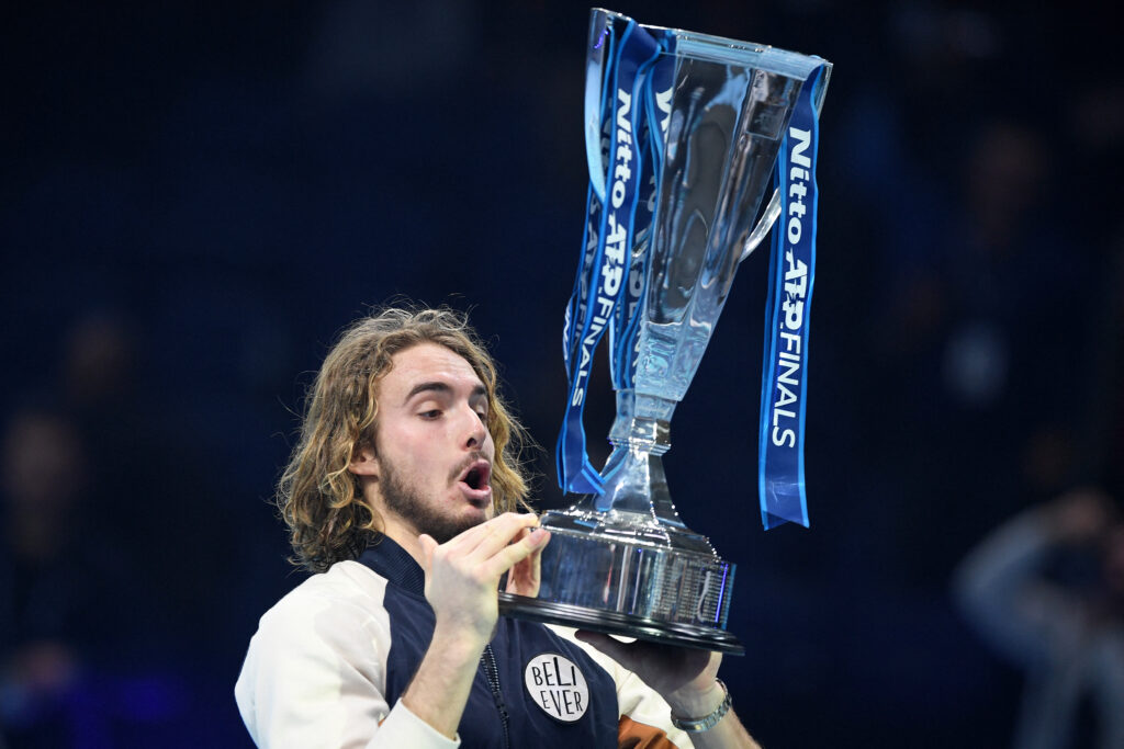 Stefanos Tsitsipas celebrates with the ATP Finals trophy in 2019