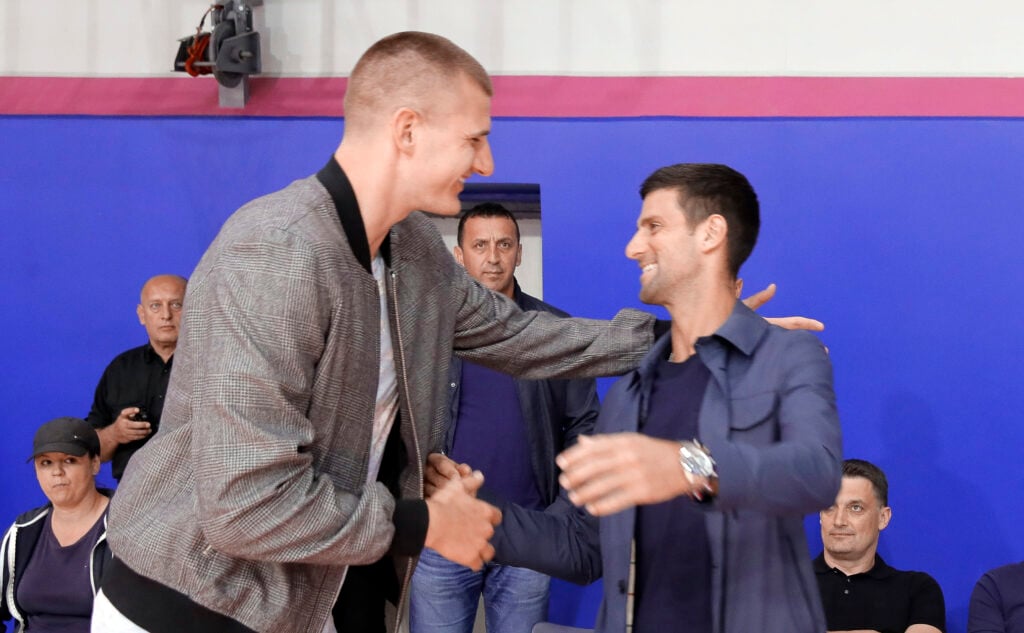 Denver Nuggets basketball player Nikola Jokic (L) of Serbia and Novak Djokovic (R) of Serbia shake hands during the farewell basketball match of head coach Dejan Milojevic on June 11, 2020 in Belgrade, Serbia.