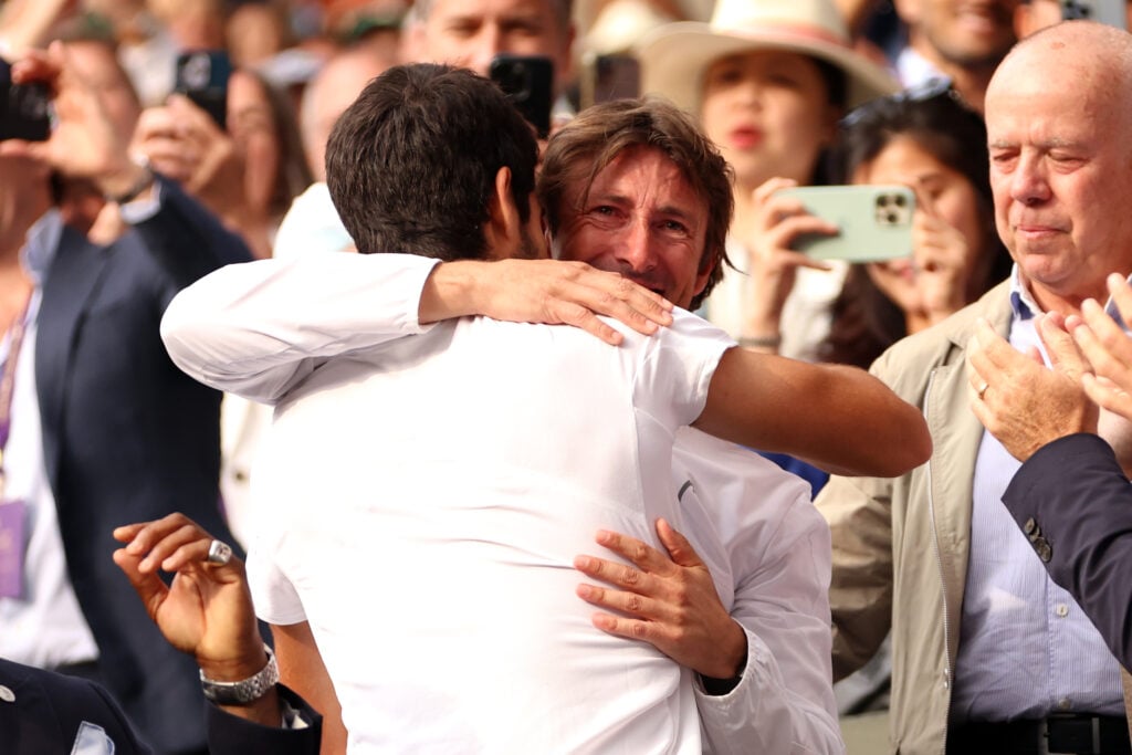 Carlos Alcaraz and Juan Carlos Ferrero embrace after Wimbledon in 2023