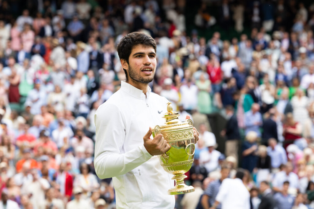 Carlos Alcaraz holds the Wimbledon trophy after beating Novak Djokovic in the 2023 final.