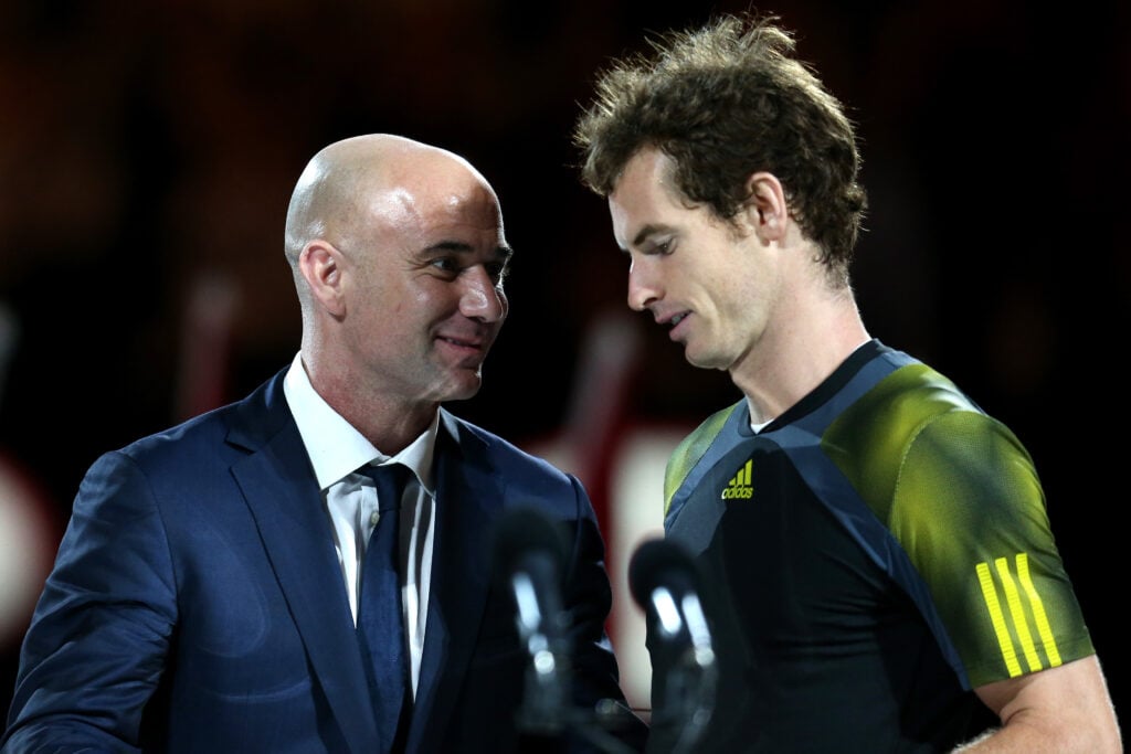 Andy Murray (R) of Great Britain speaks to Andre Agassi after losing his men's final match against Novak Djokovic of Serbia during day fourteen of the 2013 Australian Open at Melbourne Park on January 27, 2013 in Melbourne, Australia.