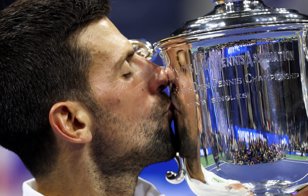 Novak Djokovic kisses the US Open trophy after winning in 2023