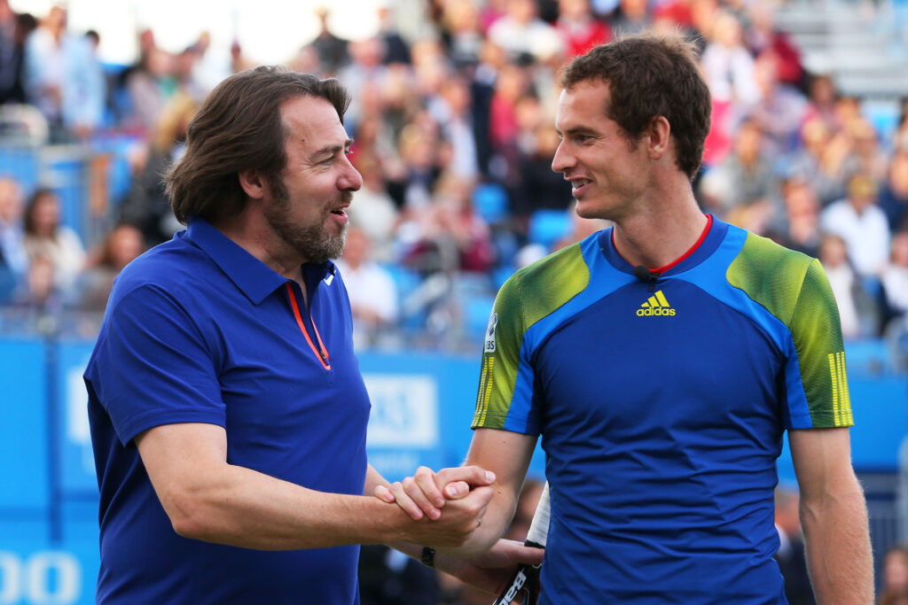 Andy Murray shakes hands with Jonathan Ross during a charity match at Queen's in 2013