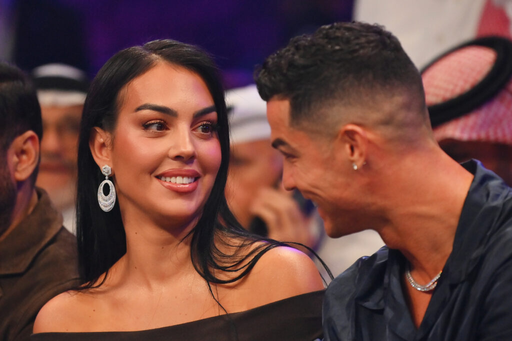 Cristiano Ronaldo and his wife Georgina Rodríguez speak ringside prior to the Heavyweight fight between Tyson Fury and Francis Ngannou at Boulevard Hall.