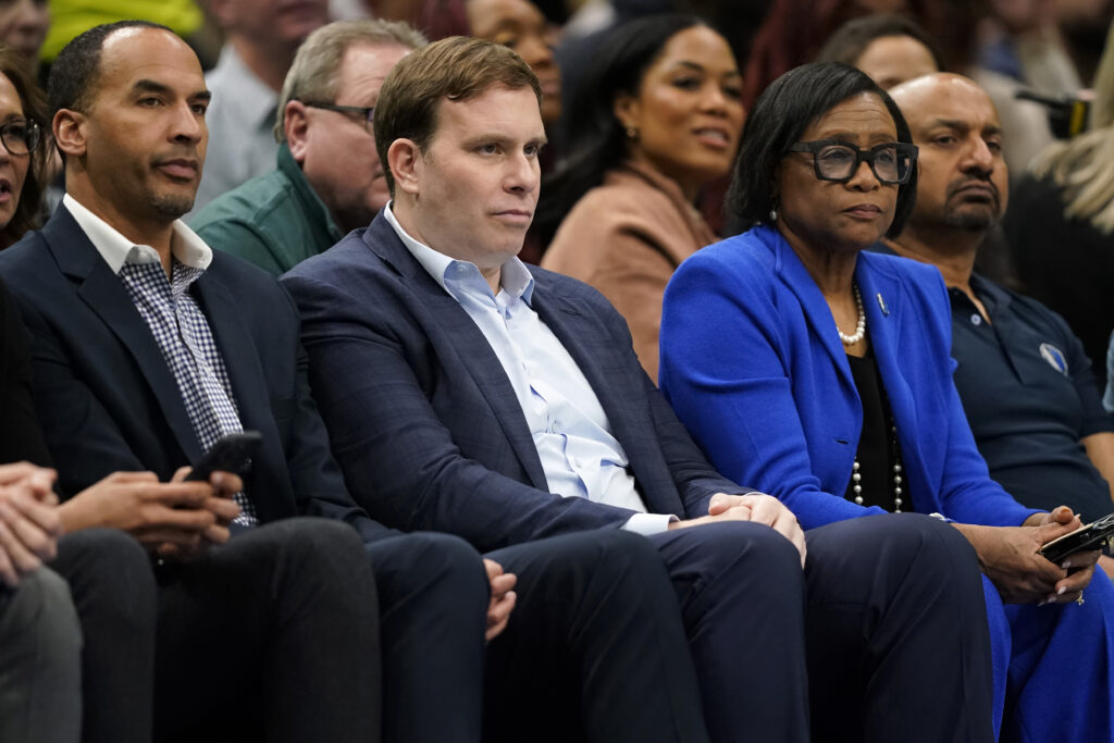 General manager Nico Harrison, new majority owner and Governor Patrick Dumont and CEO Cynt Marshall of the Dallas Mavericks watch play during the first half of the game against the Washington Wizards at American Airlines Center on February 12, 2024 in Dallas, Texas.