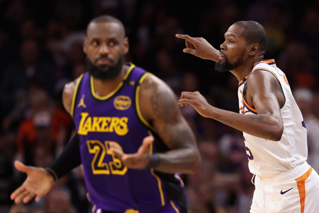 Kevin Durant #35 of the Phoenix Suns reacts after a three-point shot against LeBron James #23 of the Los Angeles Lakers during the second half of the NBA game at Footprint Center on October 28, 2024 in Phoenix, Arizona. The Suns defeated the Lakers 109-105.