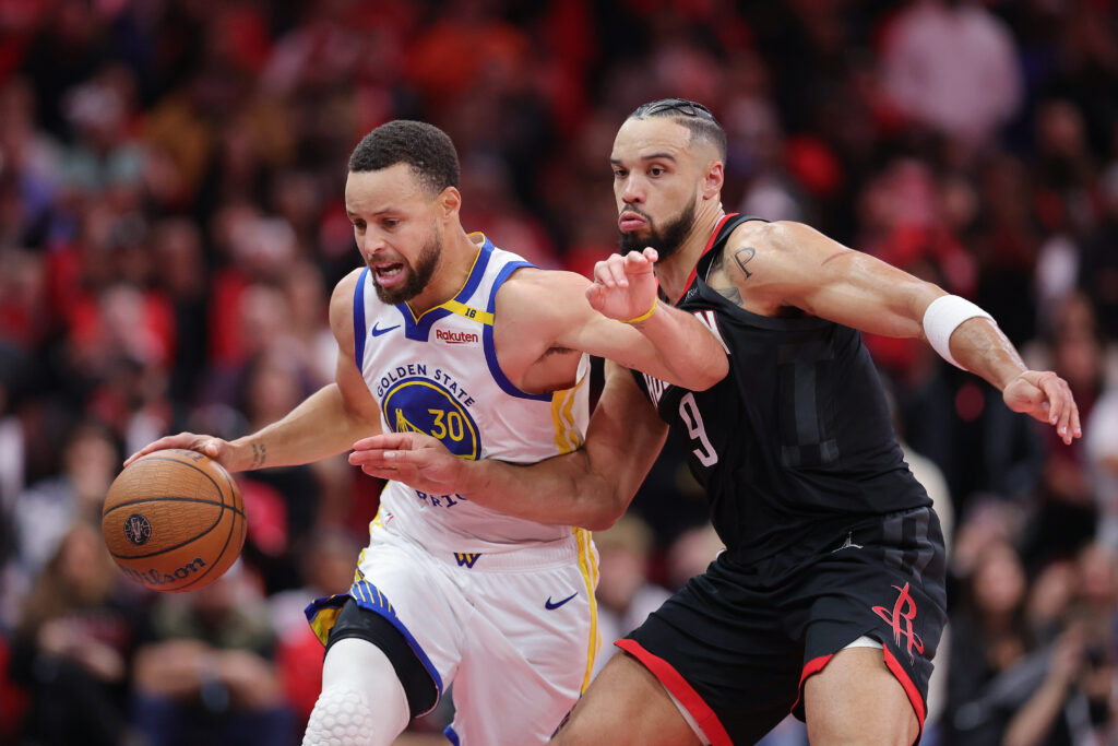 Stephen Curry #30 of the Golden State Warriors dribbles against Dillon Brooks #9 of the Houston Rockets during the second half of a quarterfinal game in the NBA Emirates Cup at Toyota Center.