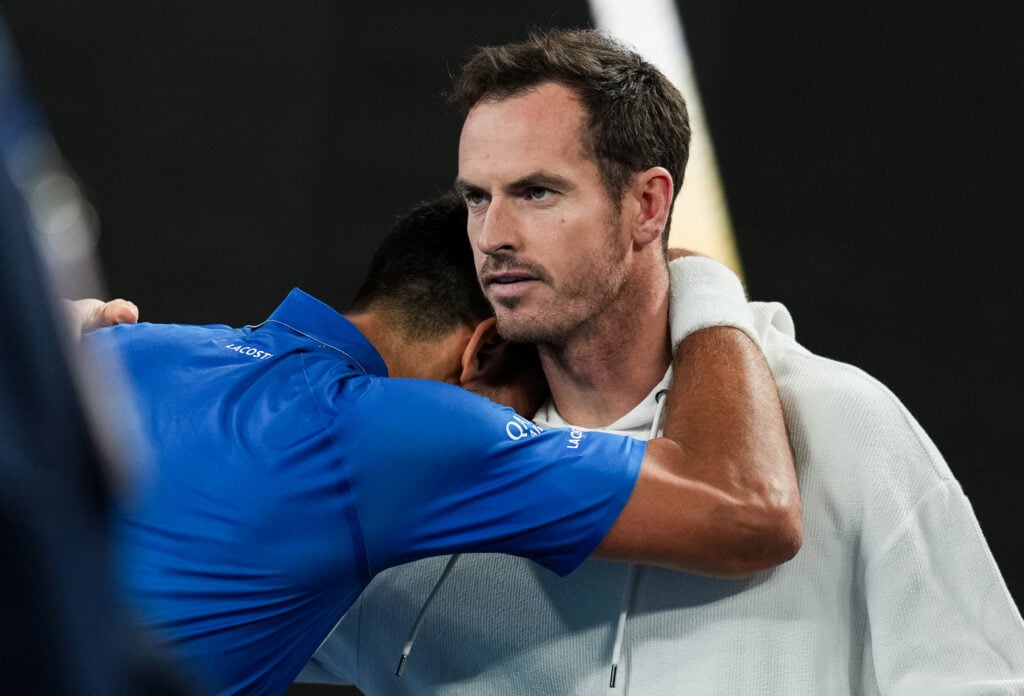 Novak Djokovic (L) of Serbia rests on the shoulder and celebrates the victory with his coach Andy Murray in the Men's Singles Quarter Finals match against Carlos Alcaraz of Spain during day ten of the 2025 Australian Open at Melbourne Park on January 21, 2025 in Melbourne, Australia.