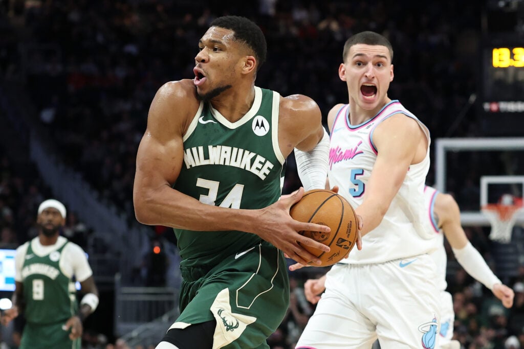 Giannis Antetokounmpo #34 of the Milwaukee Bucks is defended by Nikola Jovic #5 of the Miami Heat during the first half of a game at Fiserv Forum