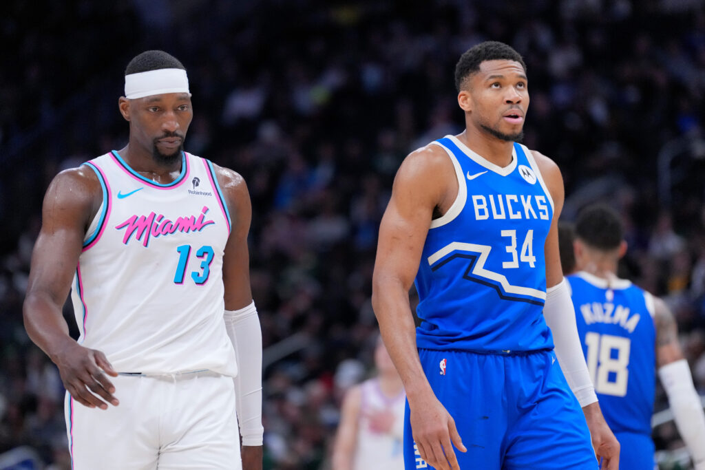Giannis Antetokounmpo #34 of the Milwaukee Bucks and Bam Adebayo #13 of the Miami Heat walk down court during the second half of the game at Fiserv Forum