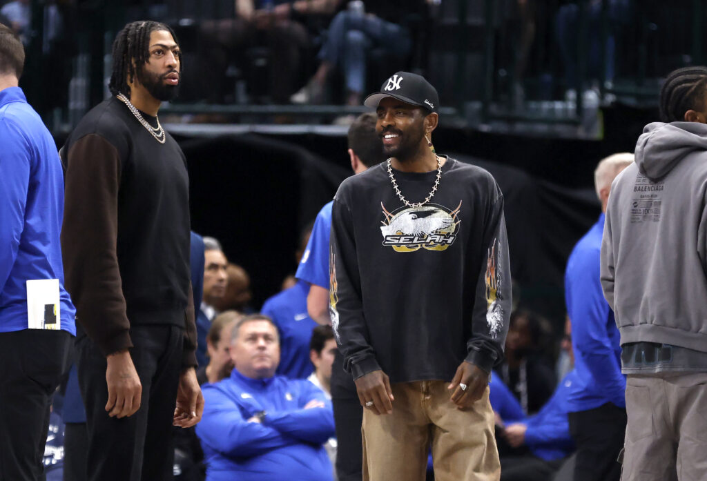 Anthony Davis #3 and teammate Kyrie Irving #11 of the Dallas Mavericks stand during a timeout against the Philadelphia 76ers during the first half at American Airlines Center on March 16, 2025 in Dallas, Texas.