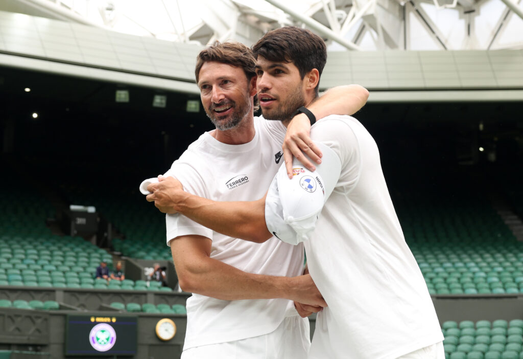 Carlos Alcaraz hugs Juan Carlos Ferrero during a practice session ahead of the 2025 Wimbledon Championships.