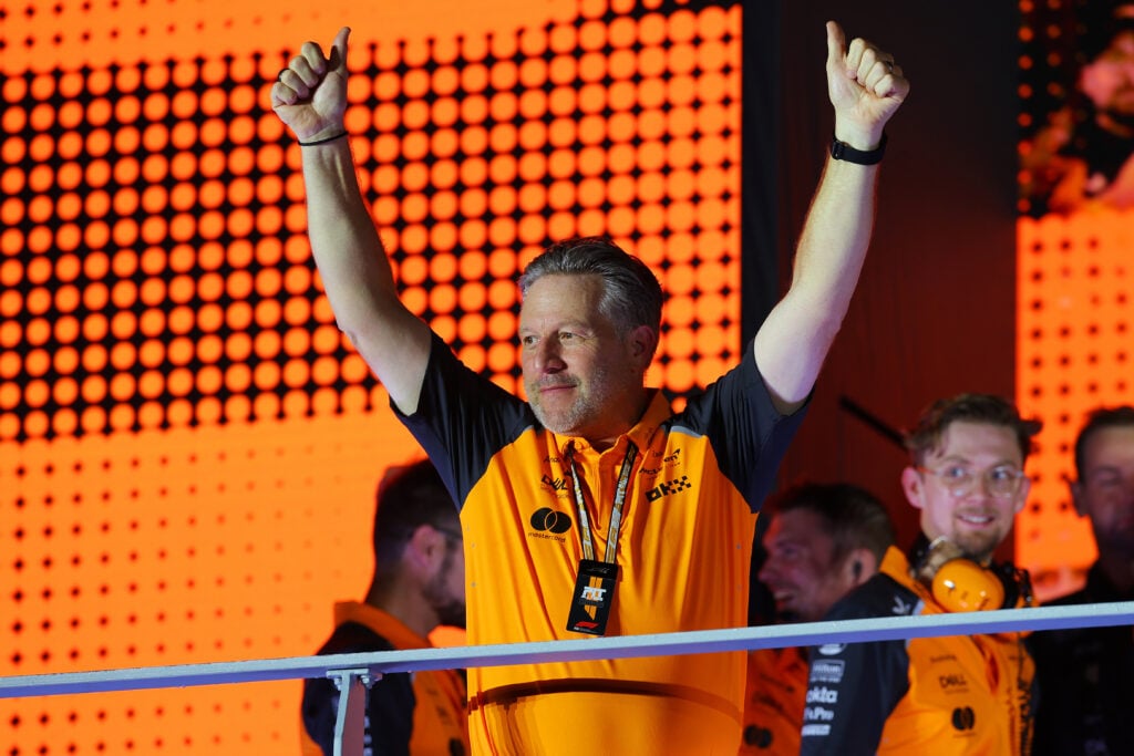Zak Brown, Chief Executive Officer of McLaren celebrates with his team after securing the Constructors Championship during the F1 Grand Prix of Singapore at Marina Bay Street Circuit on October 05, 2025 in Singapore, Singapore.