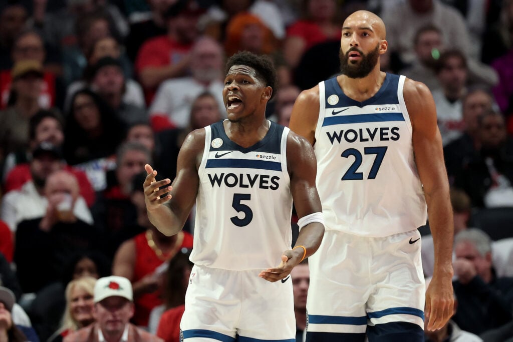 Anthony Edwards #5 and Rudy Gobert #27 of the Minnesota Timberwolves look on against the Portland Trail Blazers at Moda Center.