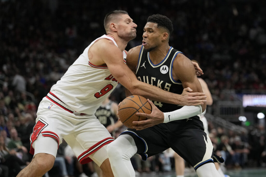 Nikola Vucevic #9 of the Chicago Bulls defends Giannis Antetokounmpo #34 of the Milwaukee Bucks in the fourth quarter of the Emirates NBA Cup.