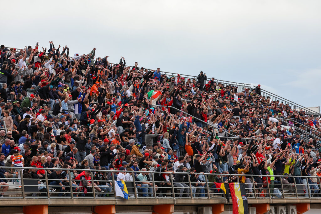 MotoGP fans doing the 'Mexican Wave' at the 2025 Valencia Grand Prix.