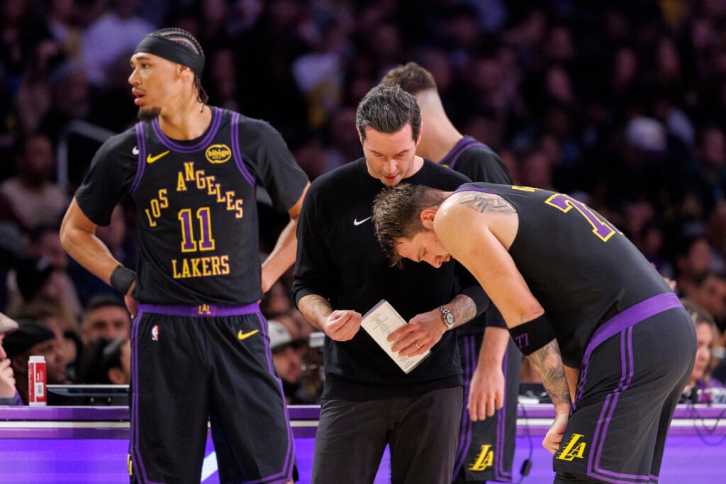 Los Angeles Lakers head coach JJ Redick chats with Los Angeles Lakers guard Luka Doncic (77) on the court during the game against the Utah Jazz at Crypto.com Arena on November 18, 2025 in Los Angeles, California.