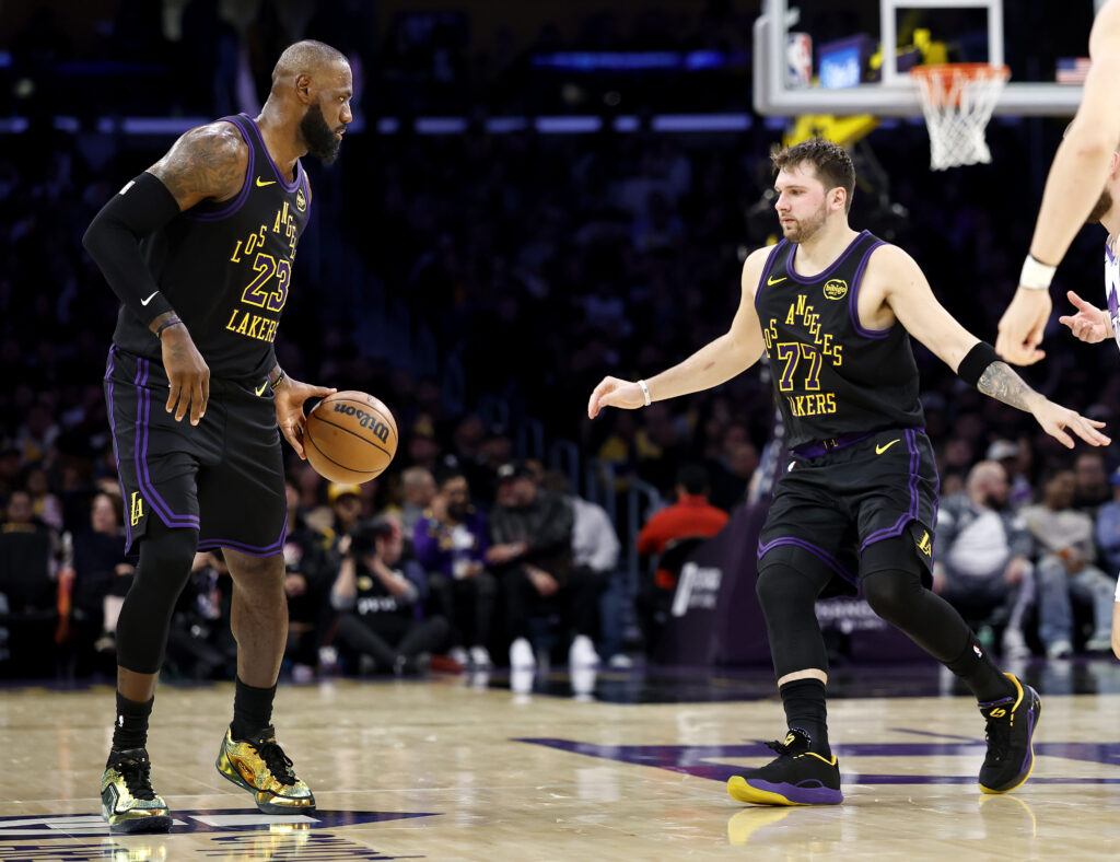 LeBron James #23 of the Los Angeles Lakers and Luka Doncic #77 in action against the Utah Jazz during the first half at Crypto.com Arena on November 18, 2025 in Los Angeles, California.