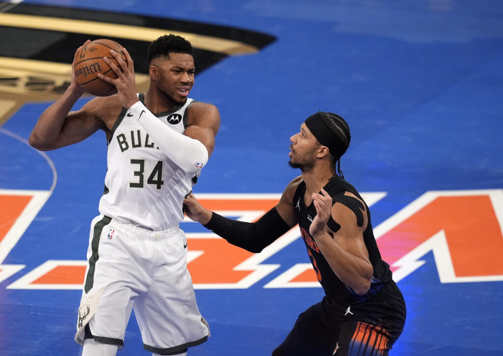 Giannis Antetokounmpo #34 of the Milwaukee Bucks controls the ball as Josh Hart #3 of the New York Knicks defends in the first quarter at Madison Square Garden