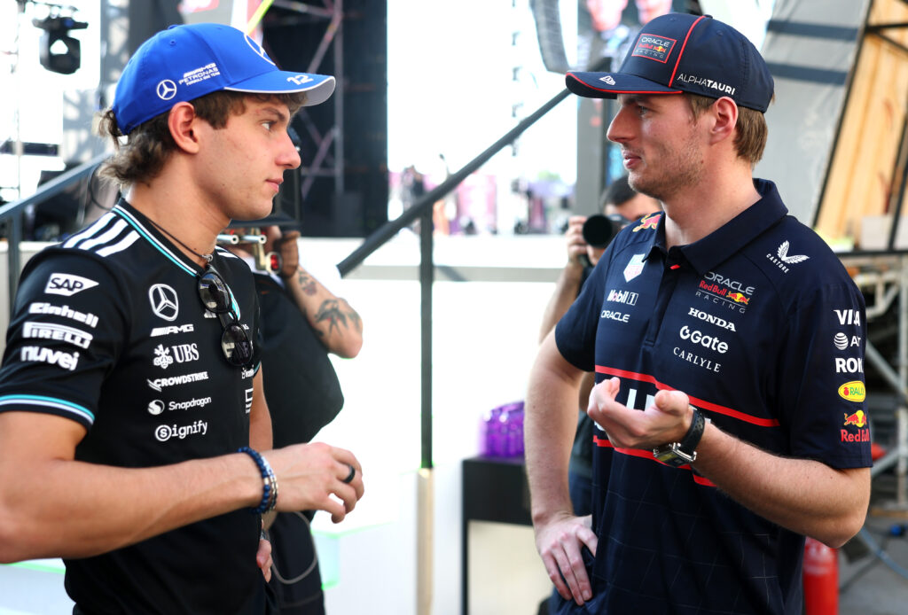 Andrea Kimi Antonelli of Italy and Mercedes AMG Petronas F1 Team and Max Verstappen of the Netherlands and Oracle Red Bull Racing talk behind the fan stage prior to the Sprint ahead of the F1 Grand Prix of Qatar at Lusail International Circuit on November 29, 2025 in Lusail City, Qatar.