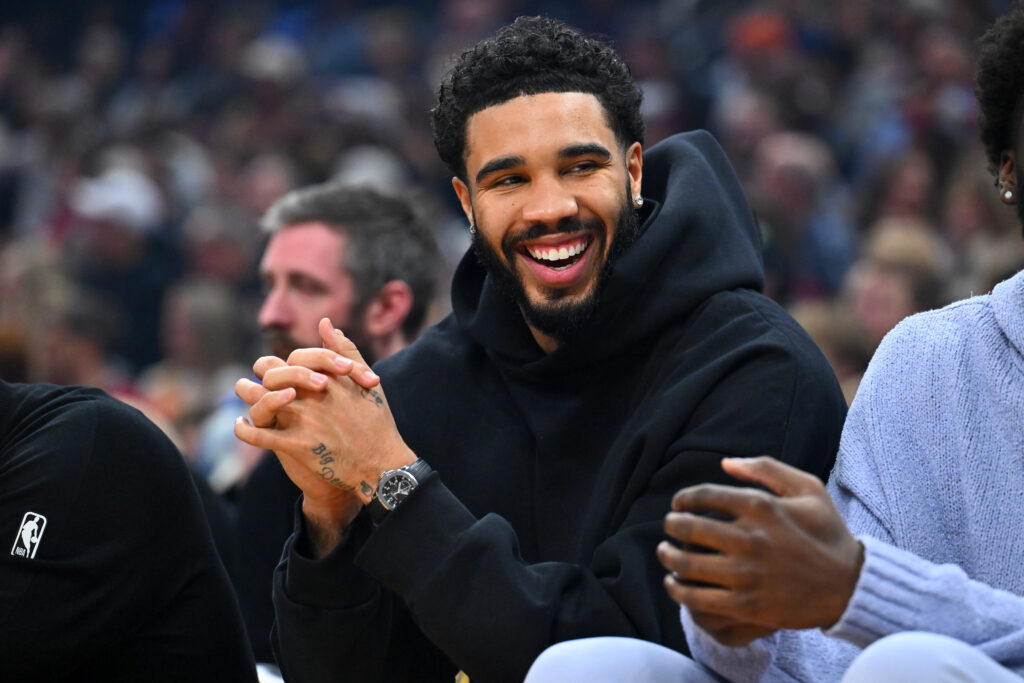 Jayson Tatum #0 of the Boston Celtics watches from the bench during the first quarter against the Cleveland Cavaliers at Rocket Arena