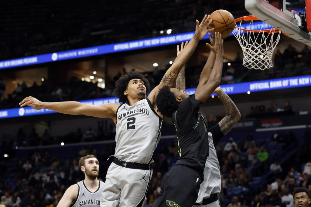 Herbert Jones #2 of the New Orleans Pelicans drives to the basket against Dylan Harper #2 of the San Antonio Spurs during the second half of a game at Smoothie King Center.