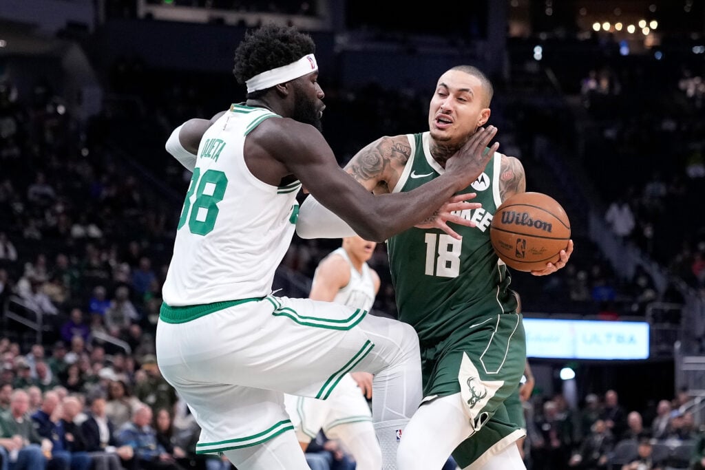 Kyle Kuzma #18 of the Milwaukee Bucks is fouled driving to the basket by Neemias Queta #88 of the Boston Celtics during the first half at Fiserv Forum