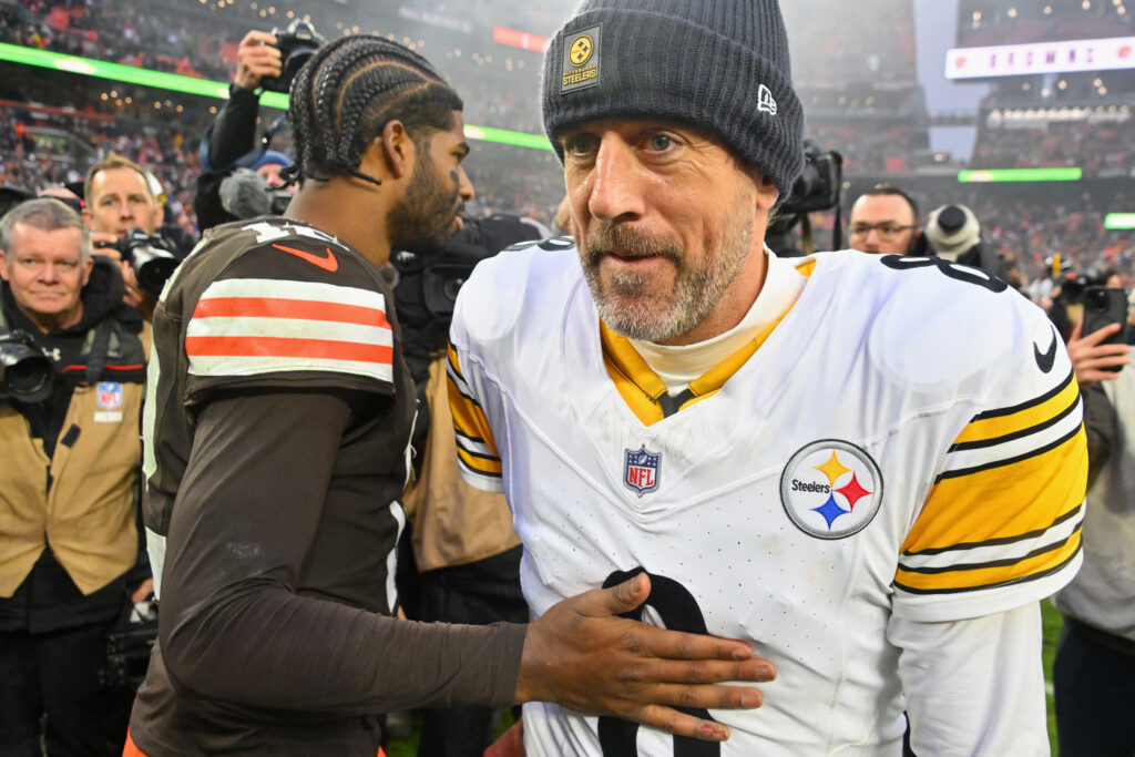 Quarterback Shedeur Sanders #12 of the Cleveland Browns greets quarterback Aaron Rodgers #8 of the Pittsburgh Steelers after the game at Huntington Bank Field on December 28, 2025.