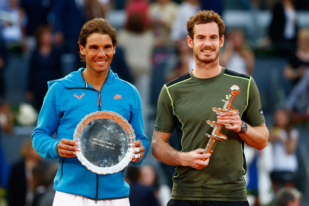 Rafael Nadal and Andy Murray pose with their titles after the 2015 Madrid Open final