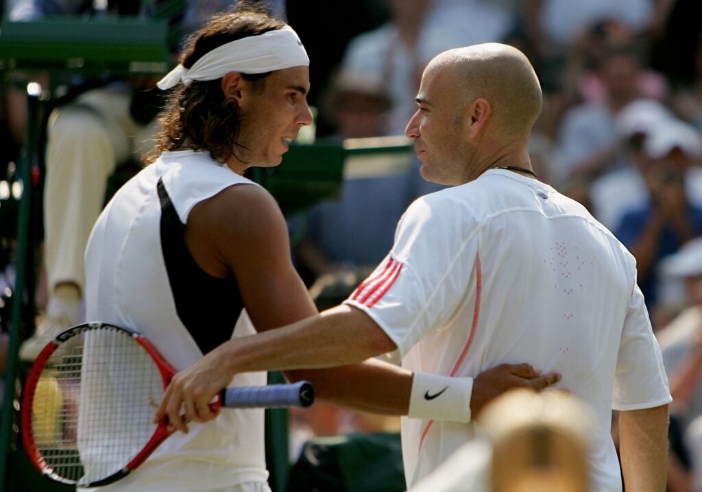 Rafael Nadal (L) of Spain speaks with Andre Agassi of the United States after he won the match during day six of the Wimbledon Lawn Tennis Championships at the All England Lawn Tennis and Croquet Club on July 1, 2006 in London, England.