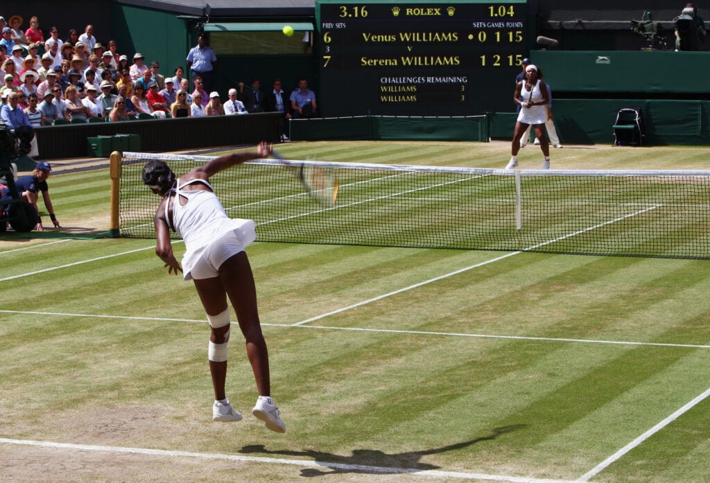 Venus Williams hitting a serve against Serena Williams during the Wimbledon singles final in 2009.