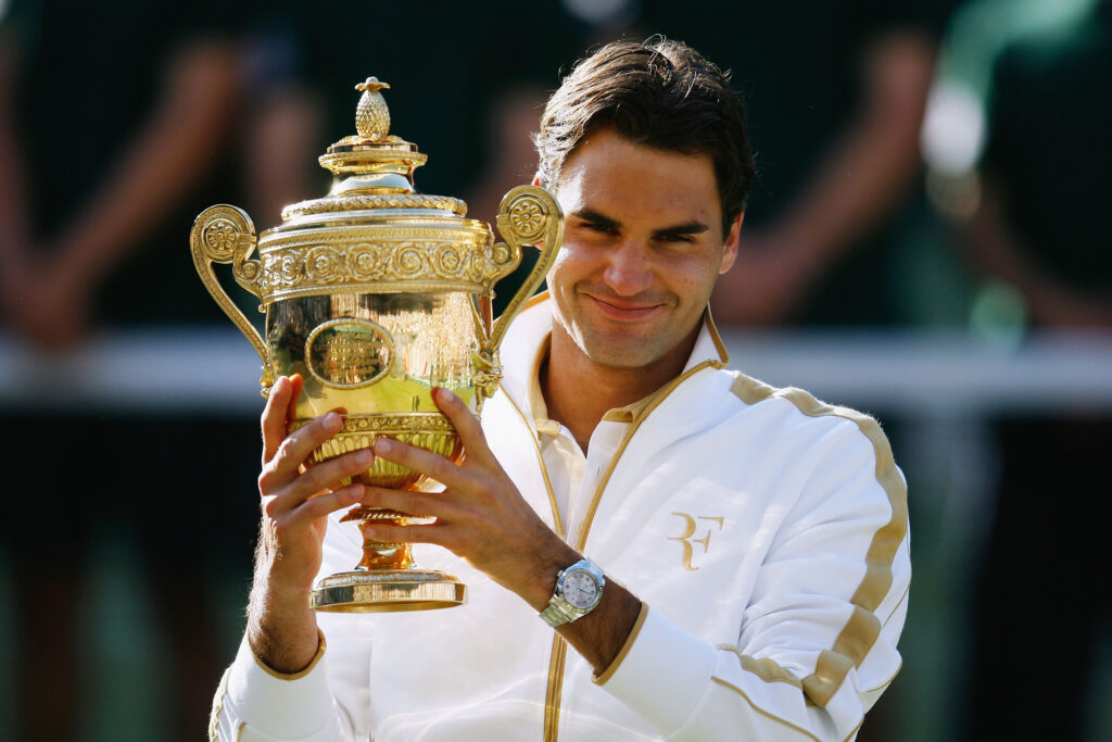 Roger Federer of Switzerland celebrates victory with the trophy after the men's singles final match against Andy Roddick of USA on Day Thirteen of the Wimbledon Lawn Tennis Championships at the All England Lawn Tennis and Croquet Club on July 5, 2009 in London, England. Federer won 5-7, 7-6, 7-6, 3-6, 16-14.