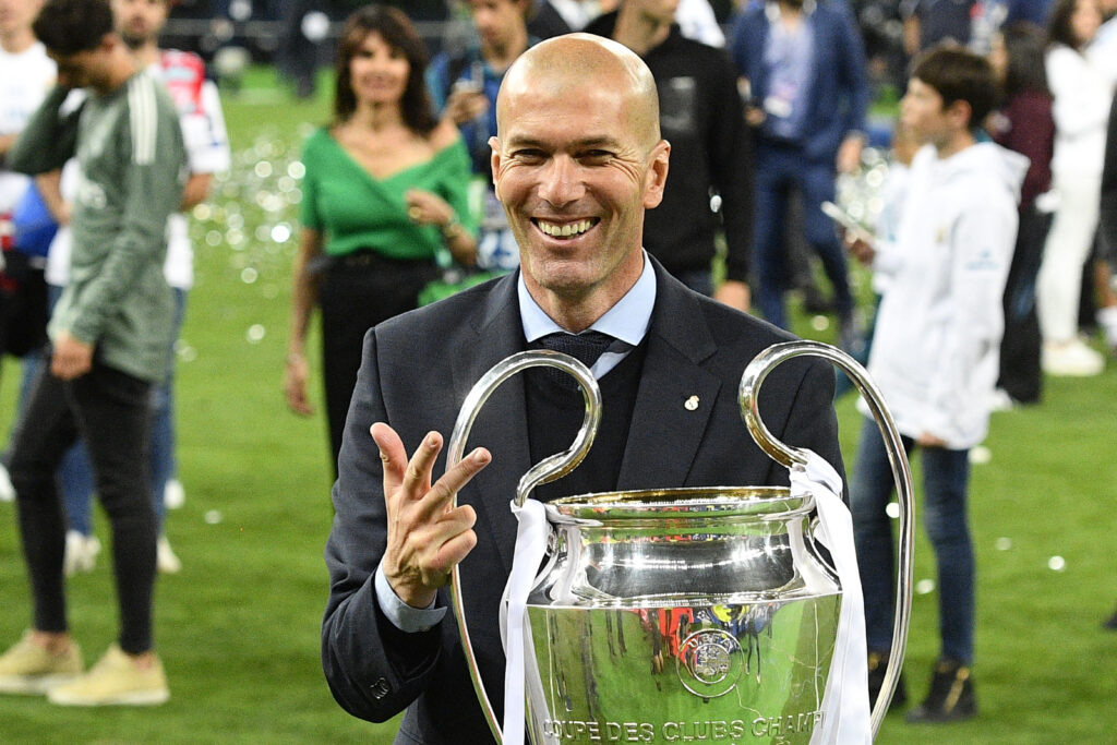 Real Madrid's French coach Zinedine Zidane poses with the trophy after winning the UEFA Champions League final football match between Liverpool and Real Madrid at the Olympic Stadium in Kiev, Ukraine, on May 26, 2018.